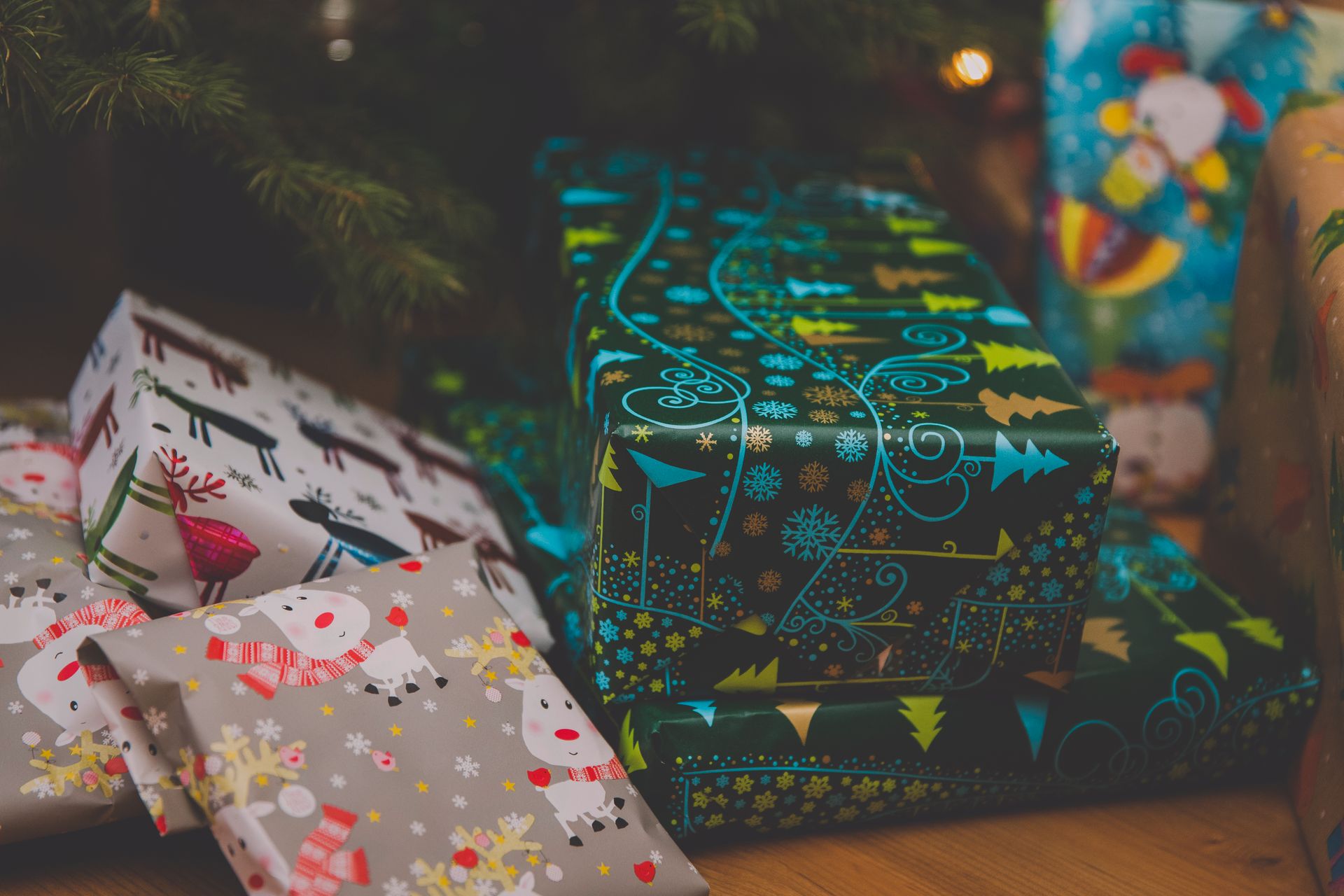 Wrapped Christmas presents under a decorated tree for Veganized Living's Secret Santa program